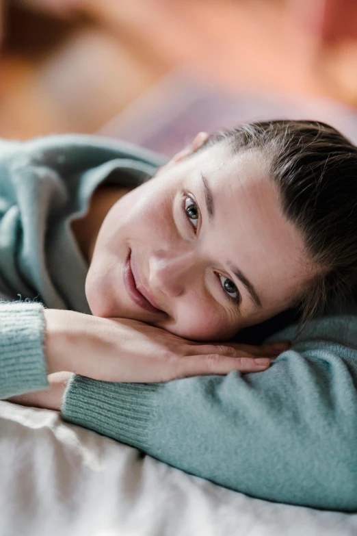 a beautiful young woman laying on top of a bed, a portrait, shutterstock contest winner, renaissance, greta thunberg smiling, soft happy smile, relaxing on the couch, androgynous person