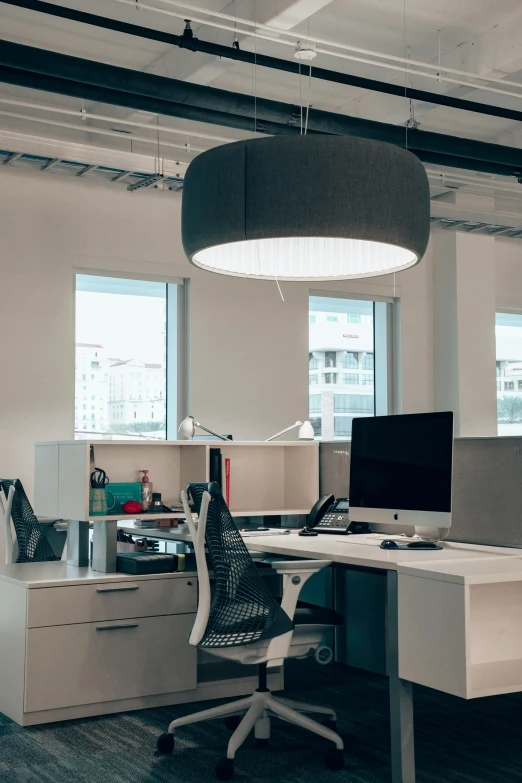 a white desk with a computer on top of it, suspended ceiling, light and dark, environmental shot, circular