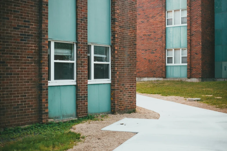 a red fire hydrant sitting in front of a brick building, a photo, inspired by Elsa Bleda, northwest school, white and teal metallic accents, space seen outside from a window, walking to the right, mass housing