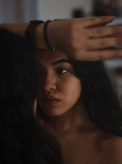 a woman brushing her hair in front of a mirror, by Adam Marczyński, trending on pexels, realism, indian girl with brown skin, portrait of depressed teen, 🤤 girl portrait, arm around her neck