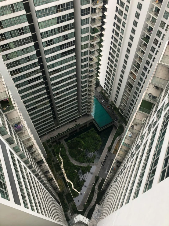 a couple of tall buildings next to each other, a picture, pexels contest winner, hyperrealism, infinity concentric pool, highly detailed # no filter, high angle close up shot, hanging gardens