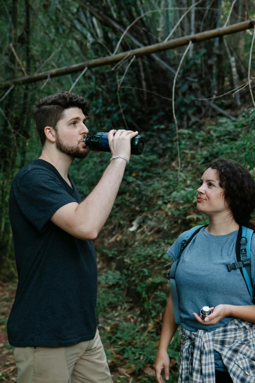 a man standing next to a woman in a forest, pexels contest winner, water bottles, inspect in inventory image, lucas films, black