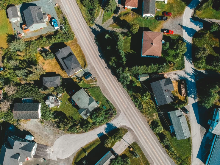 a bird's eye view of a residential neighborhood, by Roar Kjernstad, pexels contest winner, photorealism, looking down road, alaska, thumbnail, facing sideways