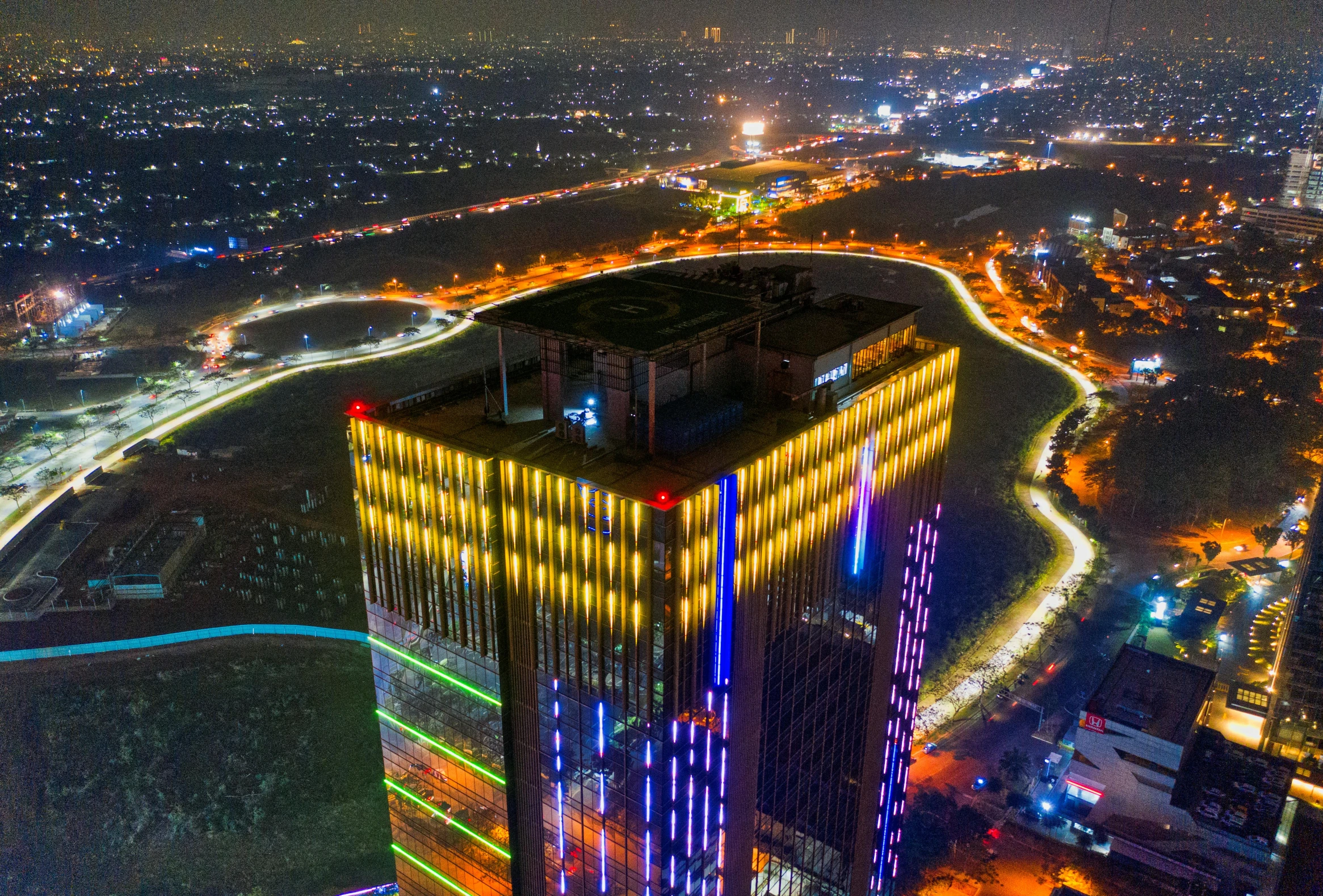 an aerial view of a city at night, pexels contest winner, realism, red - yellow - blue building, led light strips, hou china, 2 0 2 2 photo