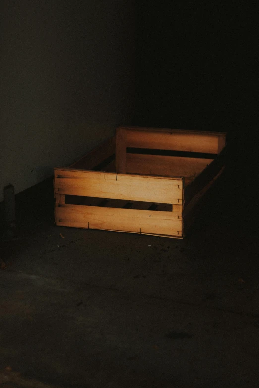 a wooden bed sitting in a dark room, an album cover, by Elsa Bleda, unsplash, arte povera, wooden crates, potato, ignant, low quality photo