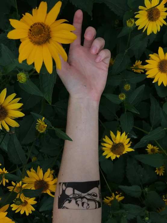 a close up of a person's arm with a wrist tattoo, a tattoo, inspired by Taro Yamamoto, pexels contest winner, helianthus flowers, the non-binary deity of spring, solar punk product photo, background image