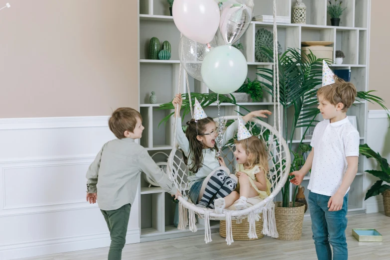 a group of children playing with balloons in a room, pexels contest winner, hurufiyya, macrame, swing on a tree, product introduction photo, decorations