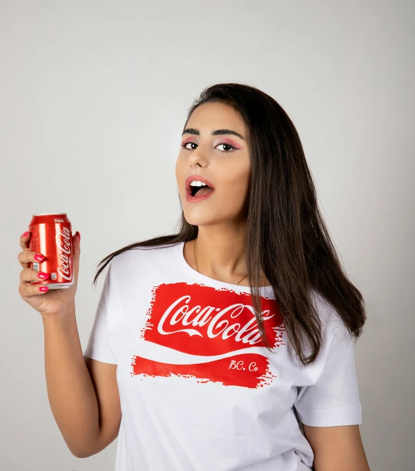 a woman holding a can of coca cola, inspired by Dorothy Coke, shutterstock contest winner, white tshirt, ameera al-taweel, fashion shoot 8k, portrait image