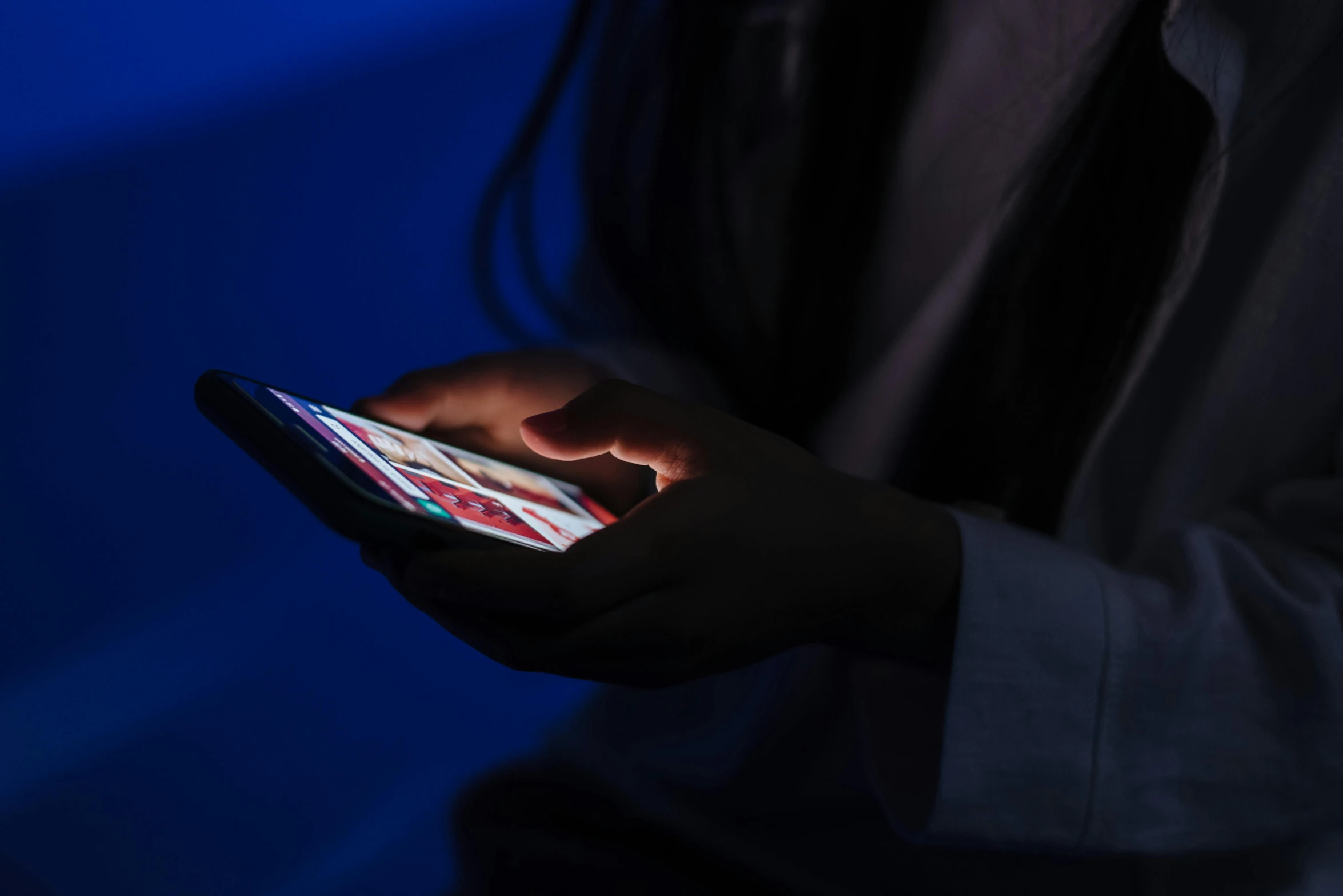 a person holding a cell phone in their hand, by Adam Marczyński, pexels, figuration libre, red and blue black light, mobile game, checking her phone, predawn