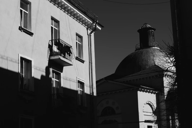 a black and white photo of a building, a black and white photo, by Andrei Kolkoutine, pexels contest winner, lviv, late afternoon sun, horse on top, :: morning