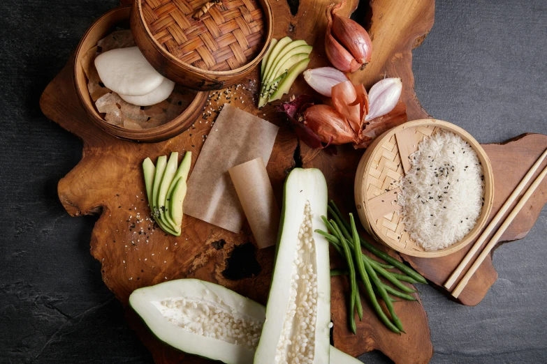 a wooden cutting board topped with lots of food, inspired by Ceferí Olivé, unsplash, renaissance, bao phan, datura, conde nast traveler photo, south east asian with round face