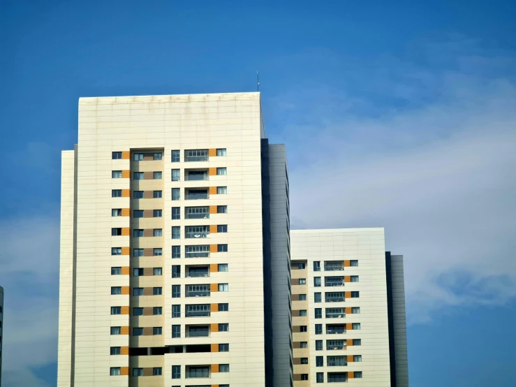 a couple of tall buildings sitting next to each other, an album cover, unsplash, modernism, clear blue sky, soviet apartment buildings, 2000s photo, getty images