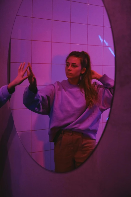 a woman that is standing in front of a mirror, a hologram, trending on pexels, antipodeans, ((purple)), sydney sweeney, asher duran, cynthwave