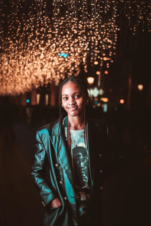 a woman standing in the middle of a street at night, an album cover, by Jakob Emanuel Handmann, pexels contest winner, silver metallic moncler jacket, smiling young woman, african american young woman, portrait of tall