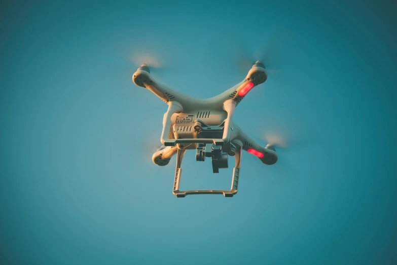 a white drone flying through a blue sky, pexels, vintage color, boston dynamics, islamic, instagram picture