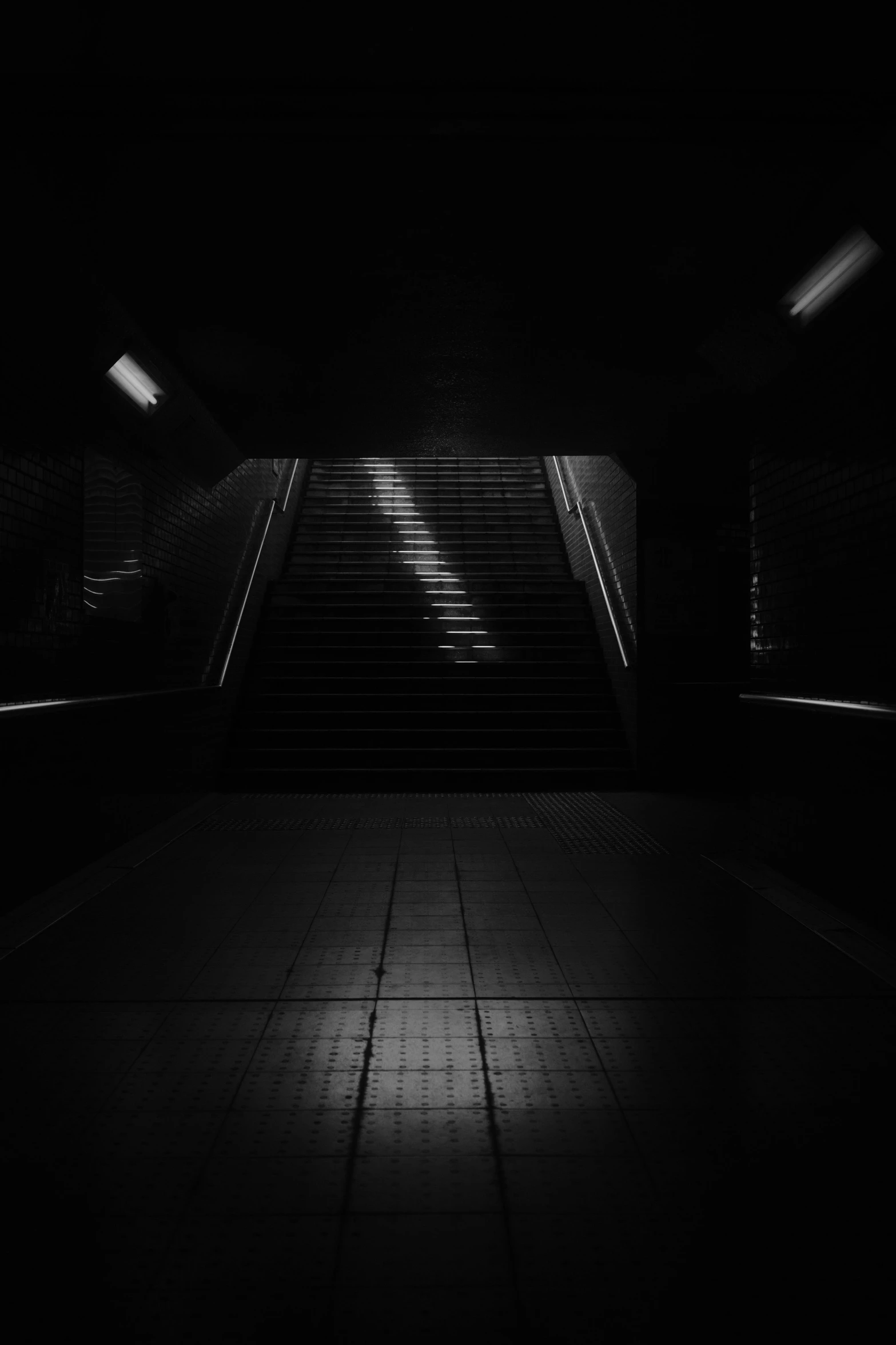 a black and white photo of an escalator, inspired by Adam Marczyński, darkness's background, dark ambient album cover, [ [ hyperrealistic ] ], scp-914