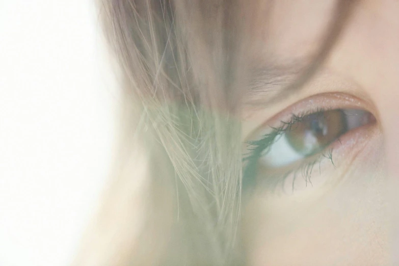 a close up of a person's eye with a blurry background, trending on pexels, girl with brown hair, high-key, eyes). full body, blond hair green eyes