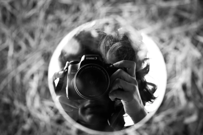 a person taking a picture of themselves in a mirror, a black and white photo, art photography, photography canon, on a mini world, # myportfolio, portrait of a big