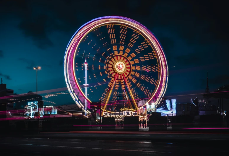 a ferris wheel is lit up at night, pexels contest winner, gigantic neon signs, unsplash 4k, vacation photo, instagram photo