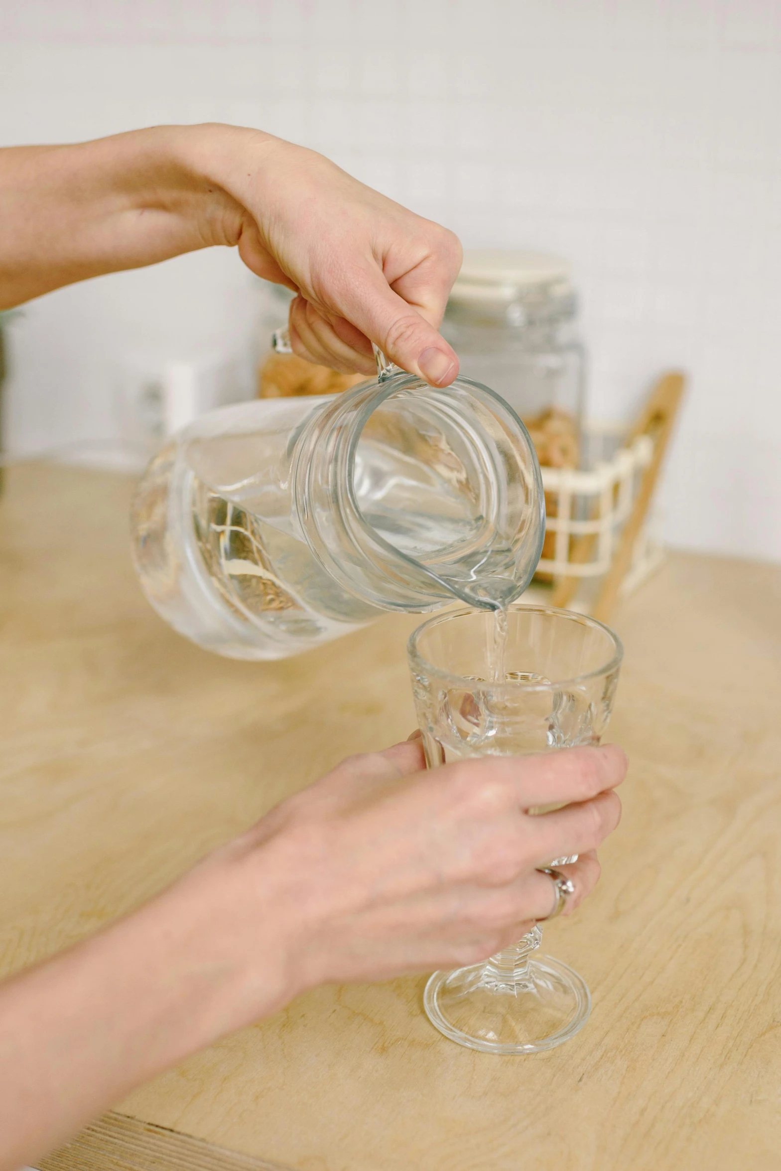 a person pouring water into a glass in a kitchen, a picture, detailed product image, silver small small small glasses, 4l, basia tran