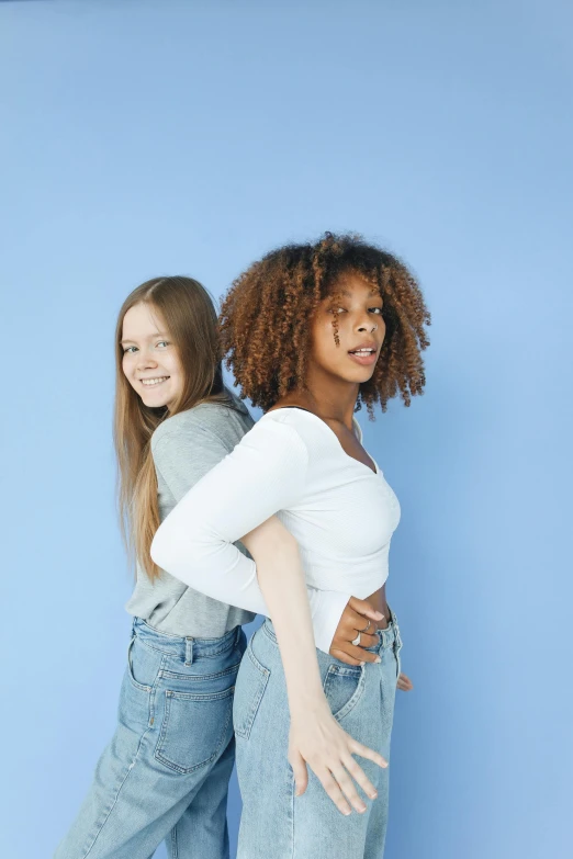 a couple of women standing next to each other, trending on pexels, renaissance, white and blue, young teen, diverse ages, arms behind back
