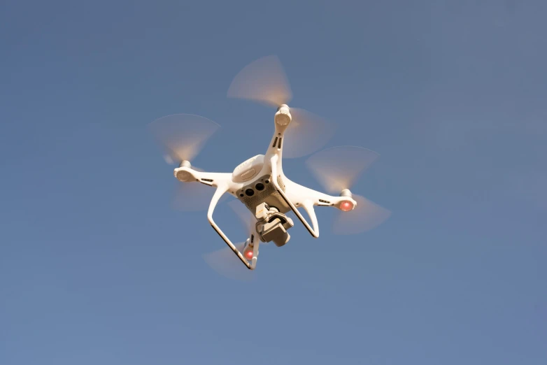 a white drone flying through a blue sky, pexels, figuration libre, square, electronics, low quality photo, 15081959 21121991 01012000 4k