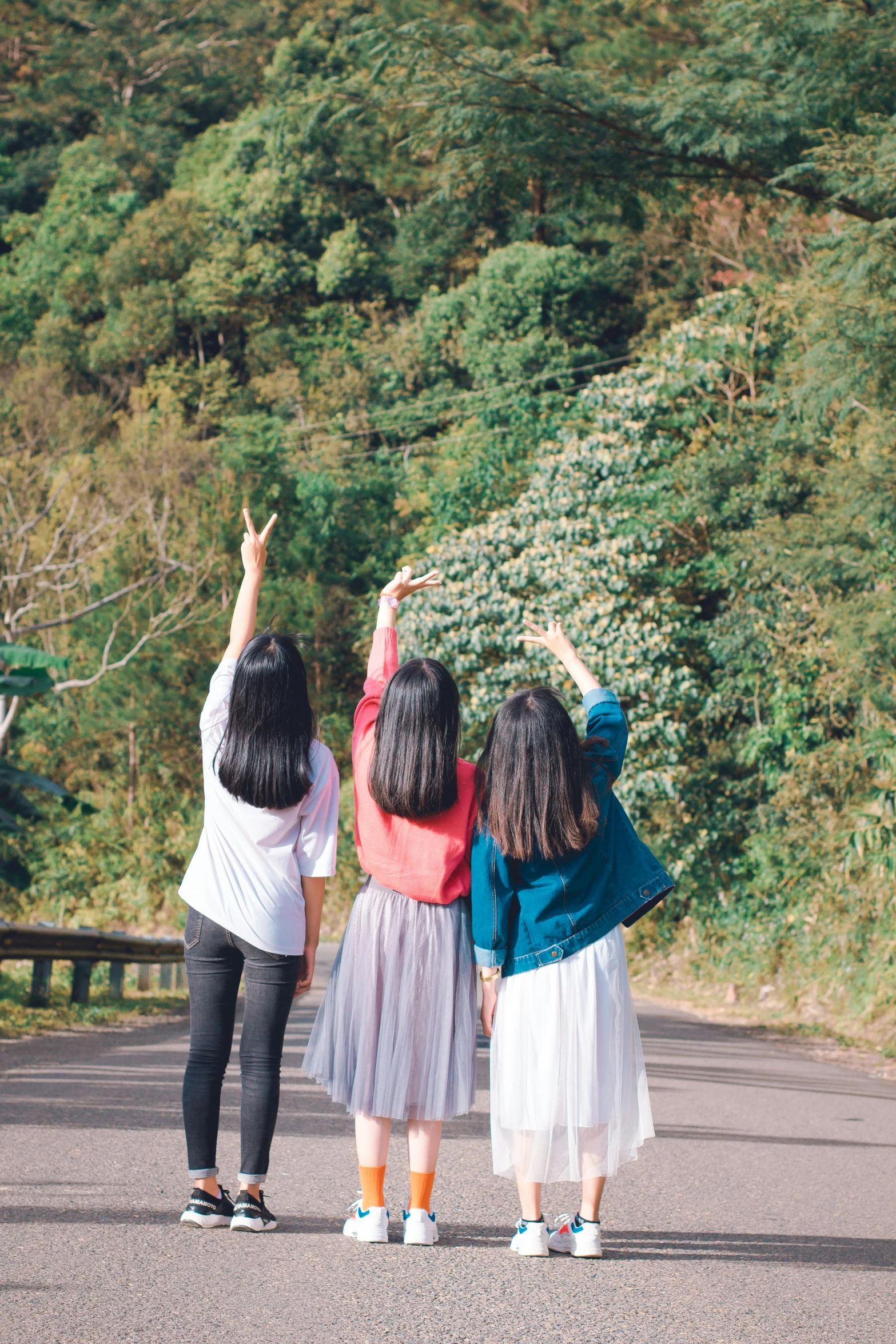 a group of girls standing next to each other on a road, inspired by Ma Yuanyu, pexels contest winner, pointing to heaven, in karuizawa, 15081959 21121991 01012000 4k, back