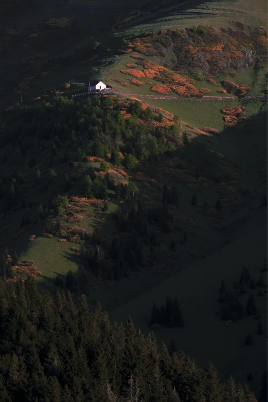 a white house sitting on top of a lush green hillside, by Wojciech Gerson, autumn sunrise warm light, cinematic shot ar 9:16 -n 6 -g, “ aerial view of a mountain, witch hut