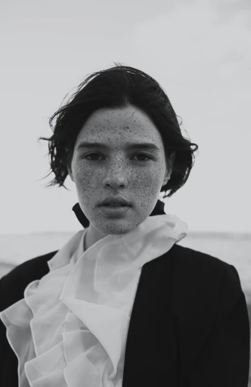 a black and white photo of a woman with freckles, inspired by Peter Lindbergh, unsplash, renaissance, black haired yoongi, a boy, dua lipa, the beach