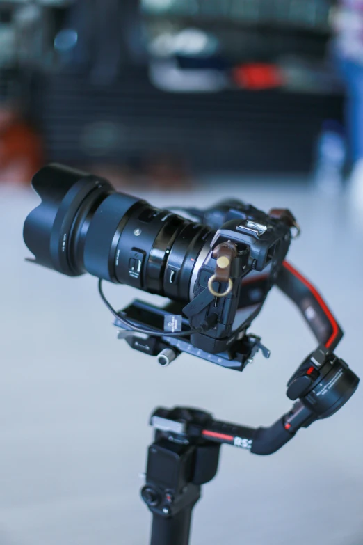 a close up of a camera on a tripod, with a robotic arm, dji top down view, f/1.8 cinematic lens, b - roll