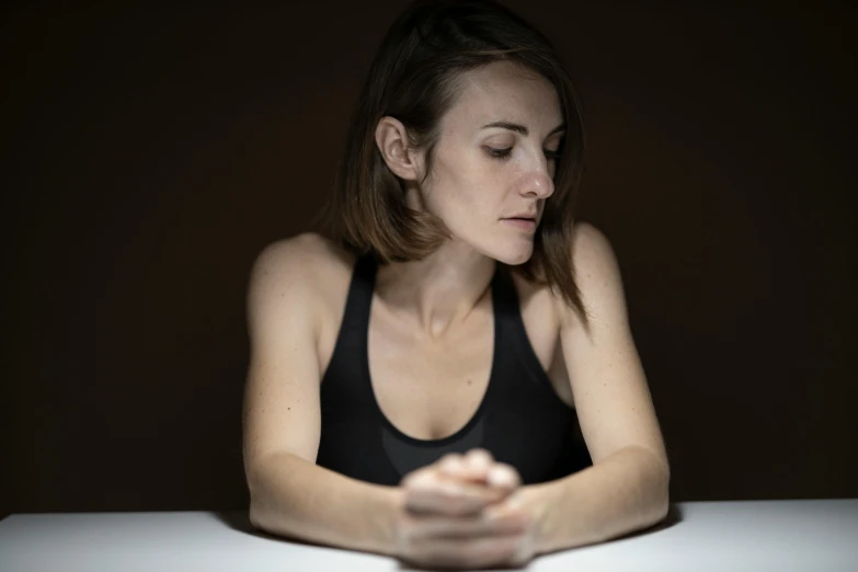 a woman sitting at a table looking at her cell phone, a portrait, inspired by Elsa Bleda, pexels, hyperrealism, depressed dramatic bicep pose, dramatic lowkey studio lighting, doing a prayer, sitting on the table