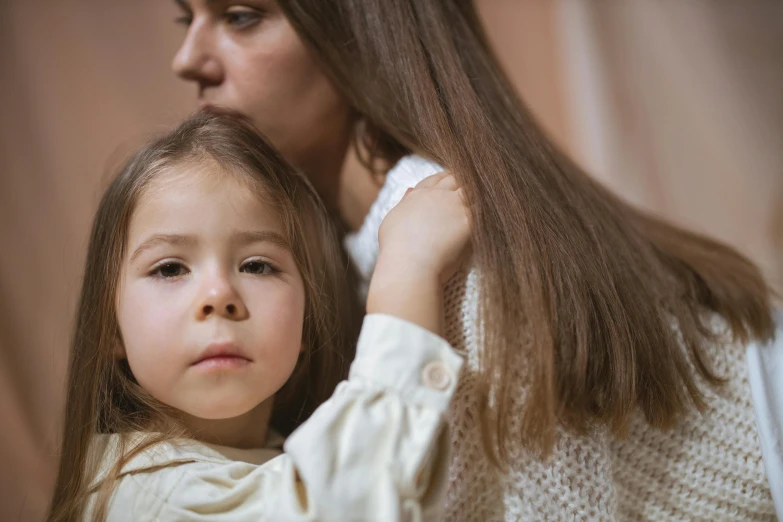 a woman combing a little girl's hair, a picture, by Emma Andijewska, shutterstock, looks sad and solemn, medium close up portrait, thumbnail, high quality picture