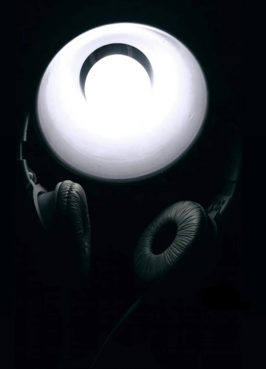 a pair of headphones sitting on top of a table, an album cover, inspired by Otto Piene, moon backlight, 1999 photograph, highcontrast, large)}]