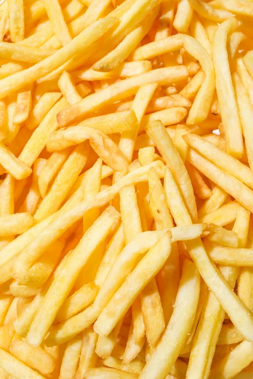 a pile of french fries sitting on top of a table, 64x64, zoomed in, yellowed, half image
