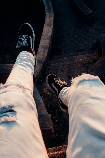 a person standing on top of a train track, by Niko Henrichon, trending on pexels, happening, ripped jeans, white on black, shoes, close up to a skinny