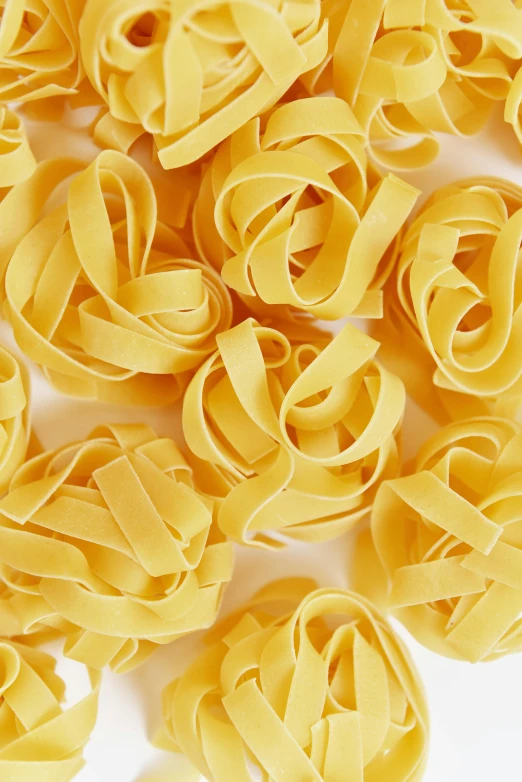a pile of pasta noodles on a white surface, renaissance, yellow aureole, extra crisp image, zoomed in, flirty