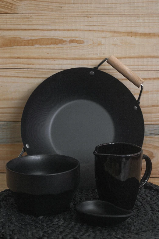 a close up of a plate and a cup on a table, pots and pans, black matte finish, prairie, gorget