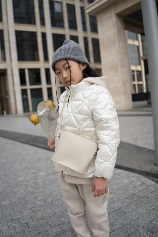 a little girl that is standing in the street, an album cover, by Nina Hamnett, instagram, happening, wearing off - white style, padded shoulders jacket, pouches, xintong chen