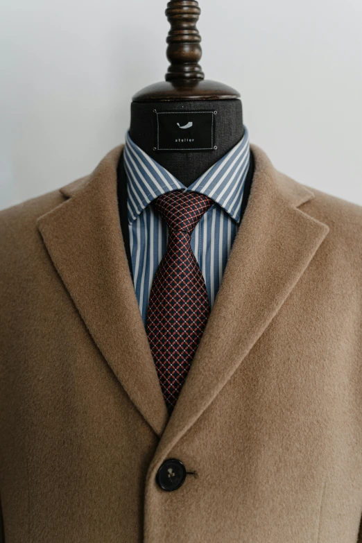 a close up of a suit and tie on a mannequin, inspired by Ramon Pichot, unsplash, renaissance, light brown coat, brown red blue, wearing black overcoat, thumbnail