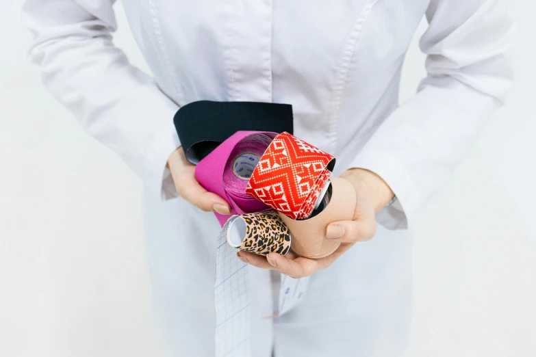 a close up of a person holding a cell phone, foot wraps, ribbon, collection product, klein bottle