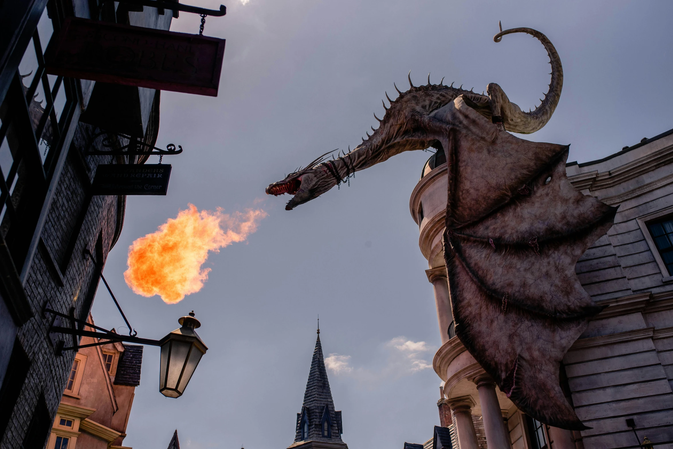 a statue of a dragon with fire coming out of it's mouth, a photo, pexels contest winner, platform 9 3 / 4, pink iconic character, magic kingdom, broomstick