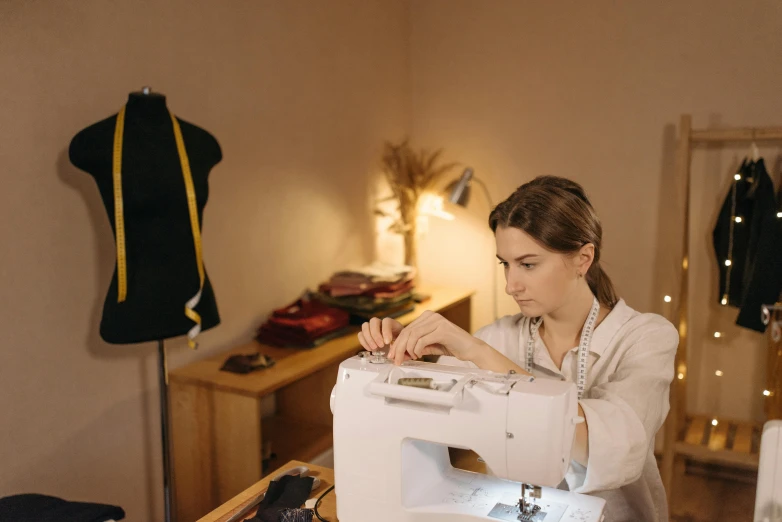 a woman working on a sewing machine in a room, profile image, digital image