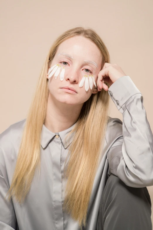 a woman with white paint on her face, an album cover, inspired by Louisa Matthíasdóttir, tumblr, sleepy fashion model face, silicone skin, annoyed, with a white complexion