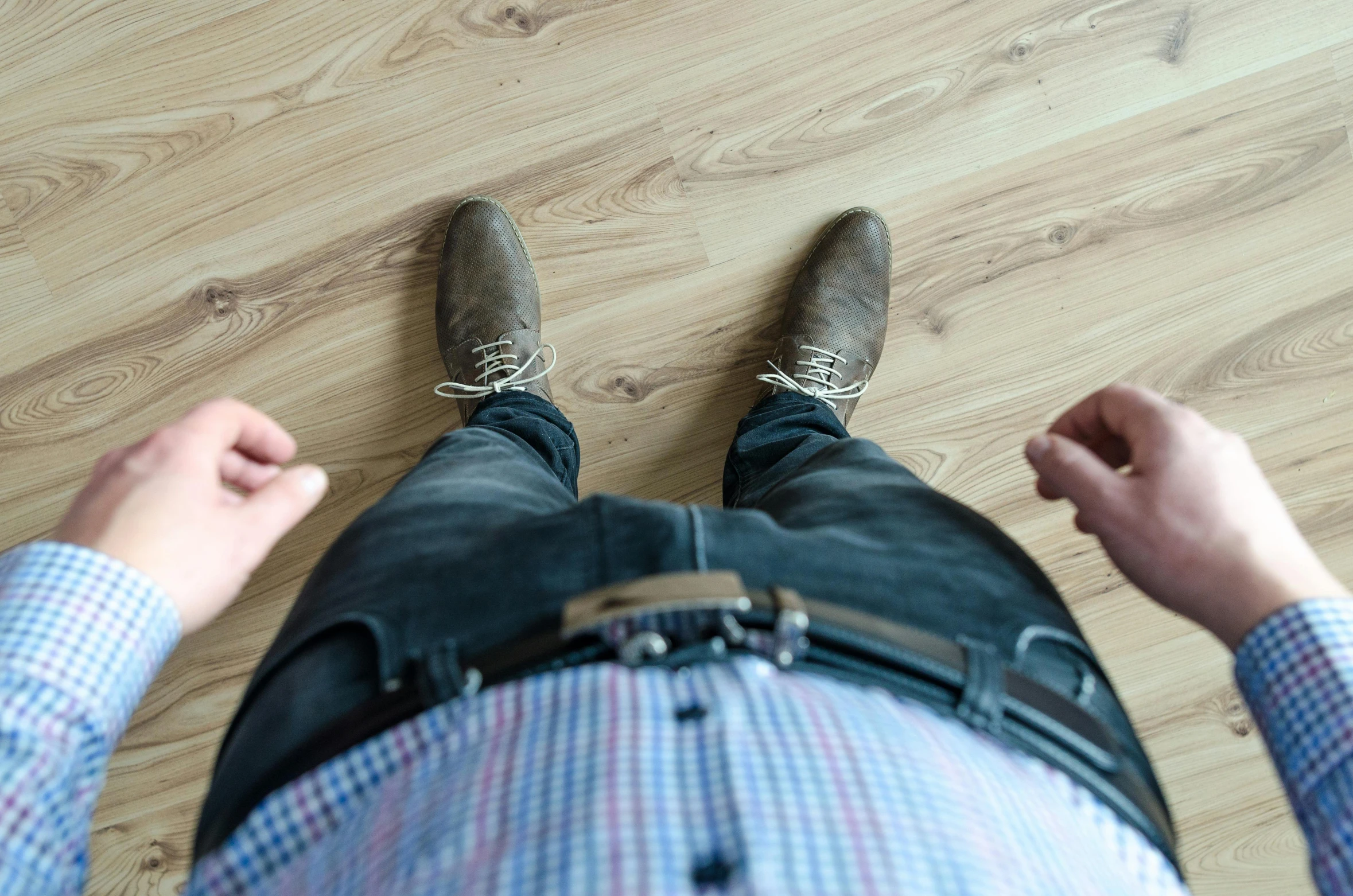 a man standing on top of a wooden floor, by Carey Morris, pexels contest winner, office clothes, slightly overweight, he has boots, folds of belly flab