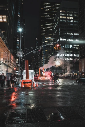 a city street filled with lots of traffic at night, attacking nyc, unsplash 4k, smokestacks at night in the rain, people at work