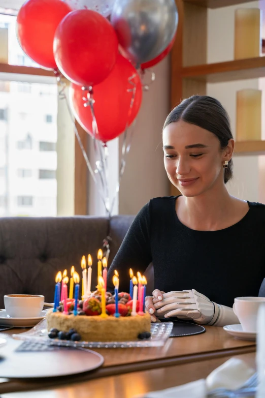 a woman sitting at a table with a birthday cake, balloons, critically acclaimed, waxy candles, profile image