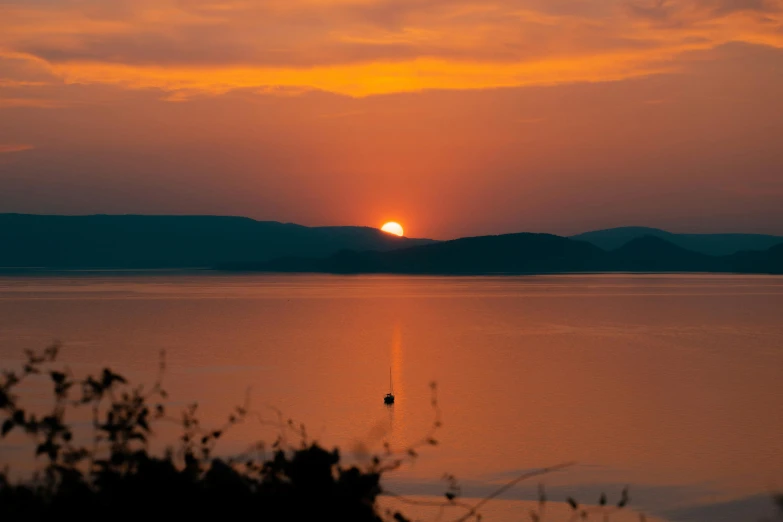 the sun is setting over a large body of water, pexels contest winner, romanticism, taras susak, viewed from a distance, skye meaker, high quality photo