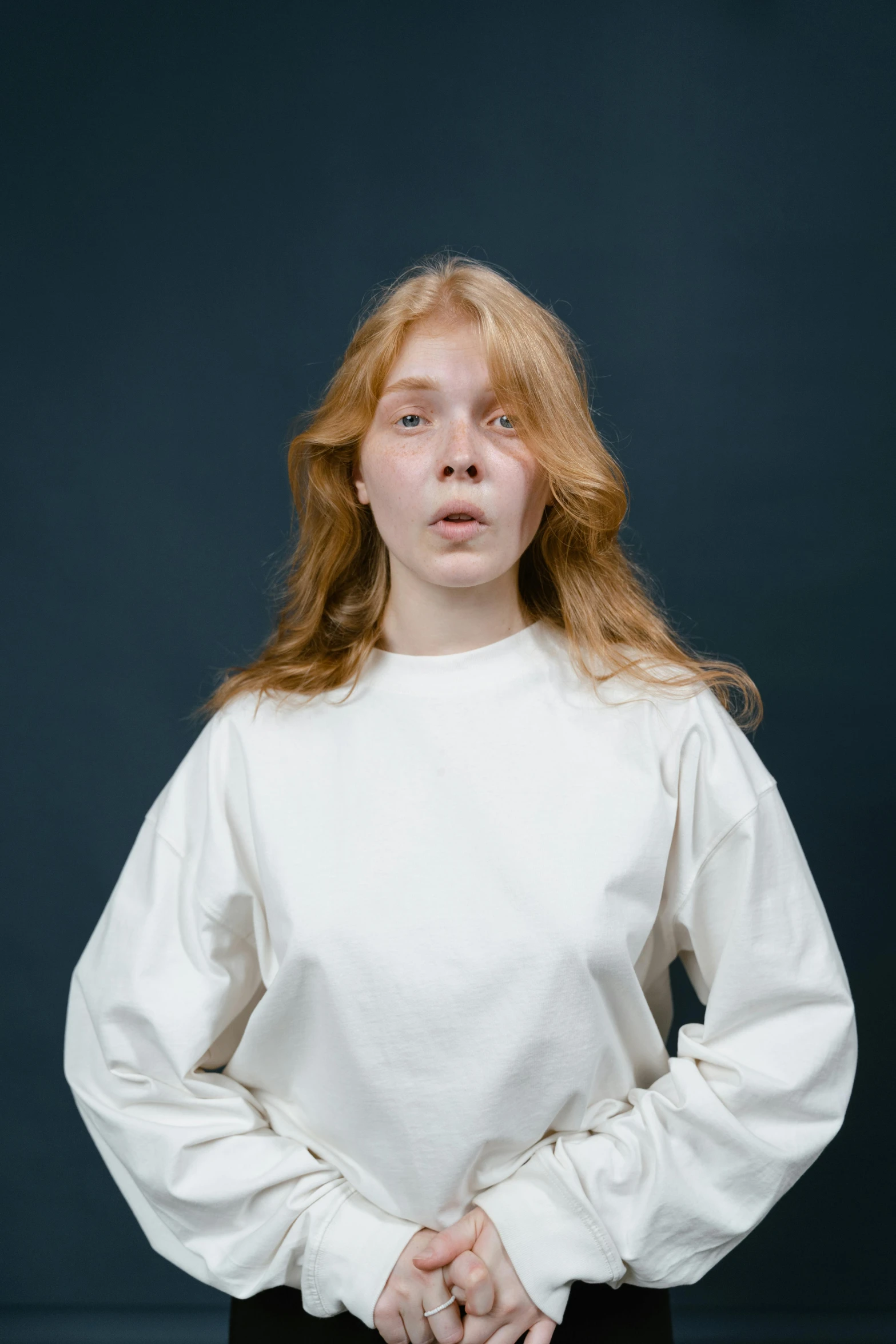 a woman in a white shirt and black pants, inspired by Lasar Segall, featured on reddit, renaissance, studio portrait photo, wearing sweatshirt, hr ginger, baggy eyes