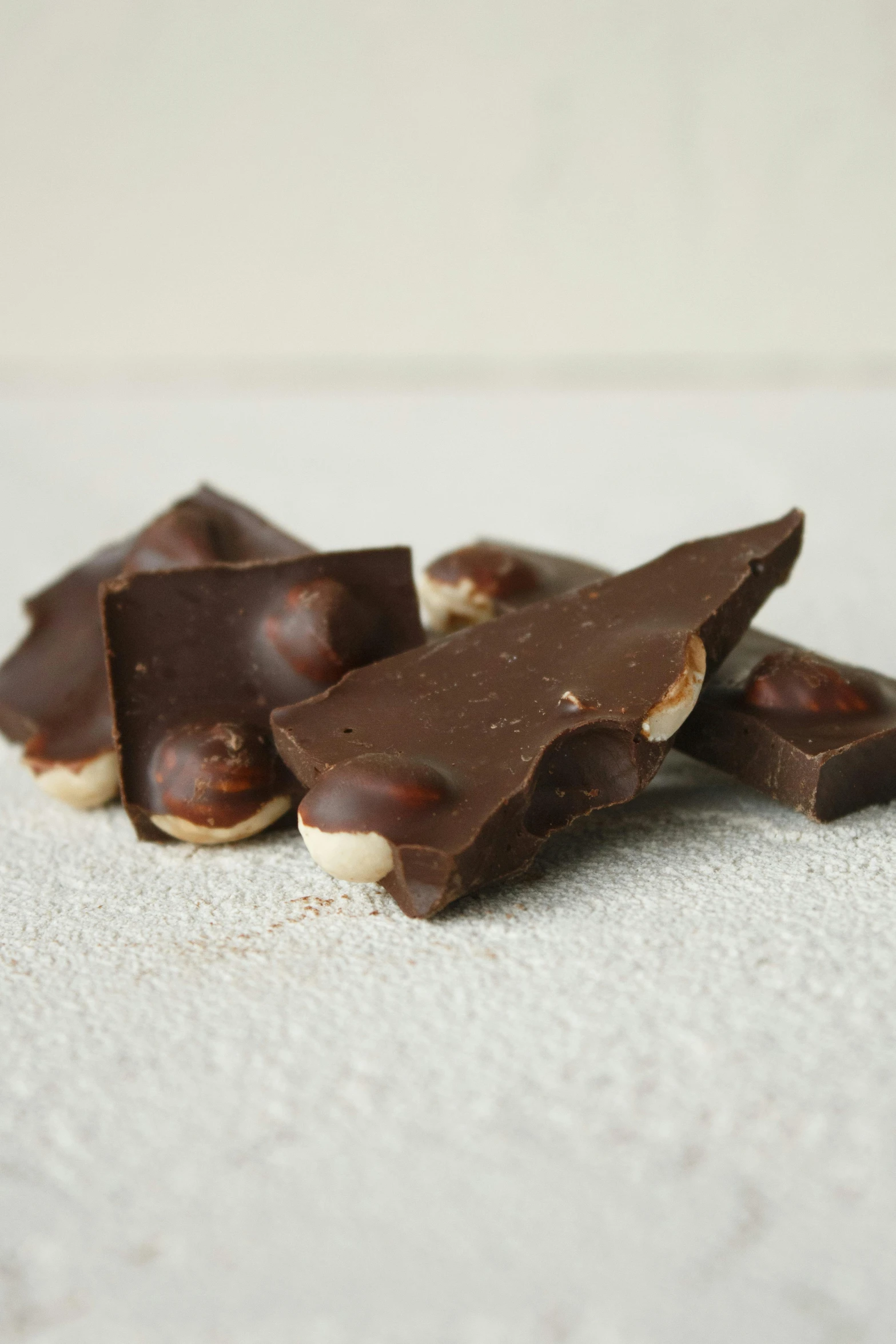 a pile of pieces of chocolate sitting on top of a table, inspired by Ödön Márffy, matte finish, marshmallow graham cracker, beans, thumbnail