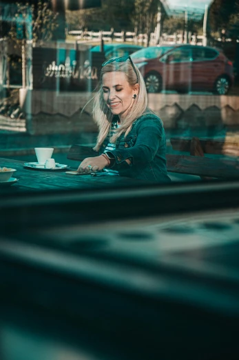 a woman sitting at a table with a cup of coffee, a picture, inspired by Elsa Bleda, pexels contest winner, happening, blonde swedish woman, square, street photo, super high resolution